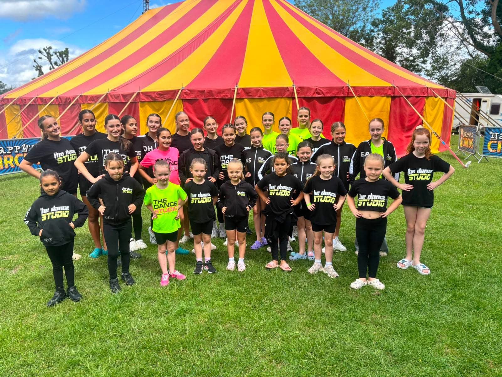 Studio group outdoors in branded kit